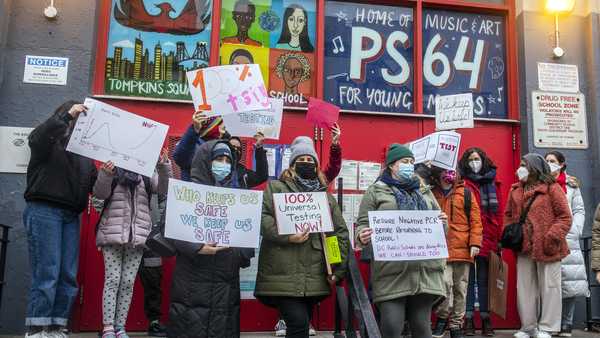 FILE — Teachers from the Earth School speak out on issues related to lack of coronavirus testing outside P.S. 64, Dec. 21, 2021, in New York.