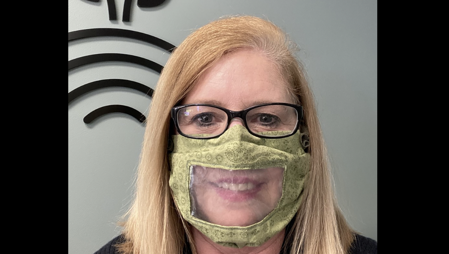 Dr. Sheri Mello handed out the clear masks to hearing-impaired patients.