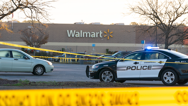 Law enforcement work the scene of a mass shooting at a Walmart, Wednesday, Nov. 23, 2022, in Chesapeake, Va. The store was busy just before the shooting Tuesday night with people stocking up ahead of the Thanksgiving holiday.