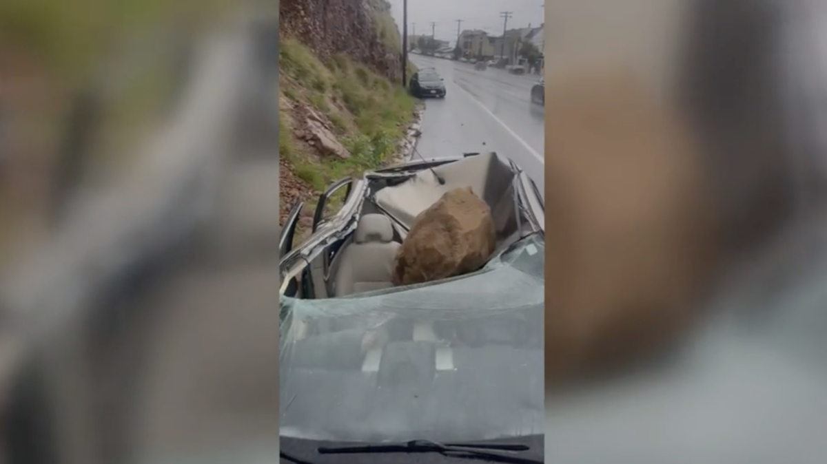 Driver gets out of car shortly before it gets crushed by boulder