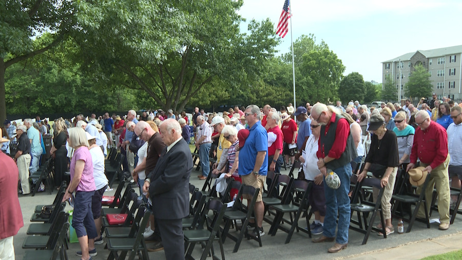 heads bowed at memorial day ceremony