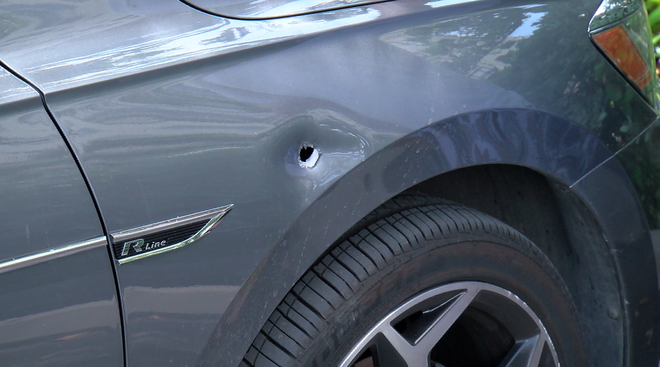 ﻿The bullet hole found in the passenger side door of the victim's car.