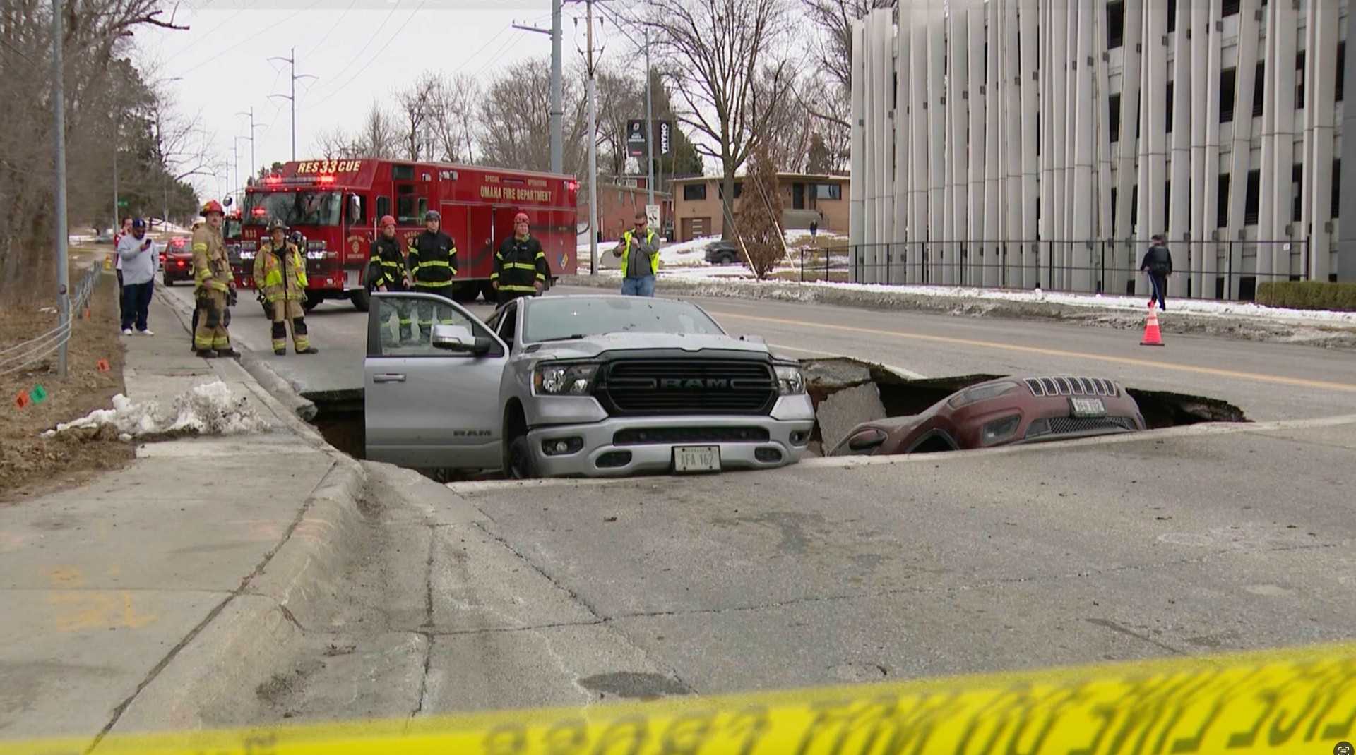 Video captures moment road collapses, leaving two vehicles stuck in Nebraska sinkhole