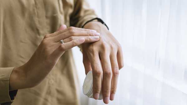 File photo of person applying lotion to hand