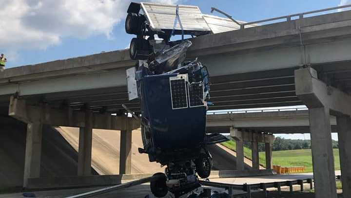 A semitruck overturned Sunday afternoon and was seen hanging off a bridge in Henryetta.