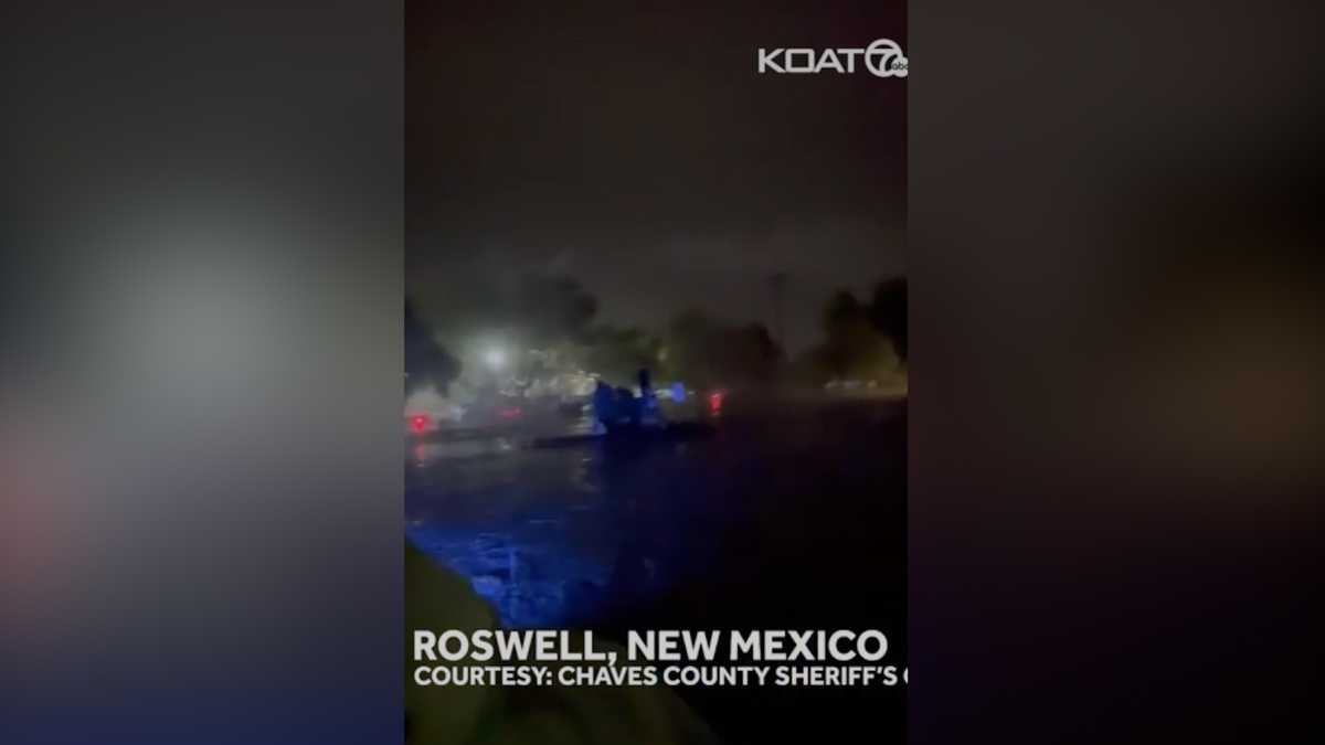 New Mexico sheriff stranded on top of police unit during flood