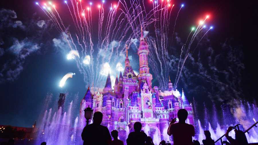 Tourists watch the celebration show marking the first anniversary of the Shanghai Disney Resort at the 196.8-foot Enchanted Storybook Castle  on June 16, 2017 in Shanghai, China.