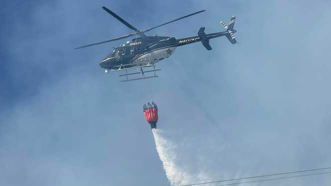 Sheriff's Office helicopter dumps water on brush fire near I-75 in North Port