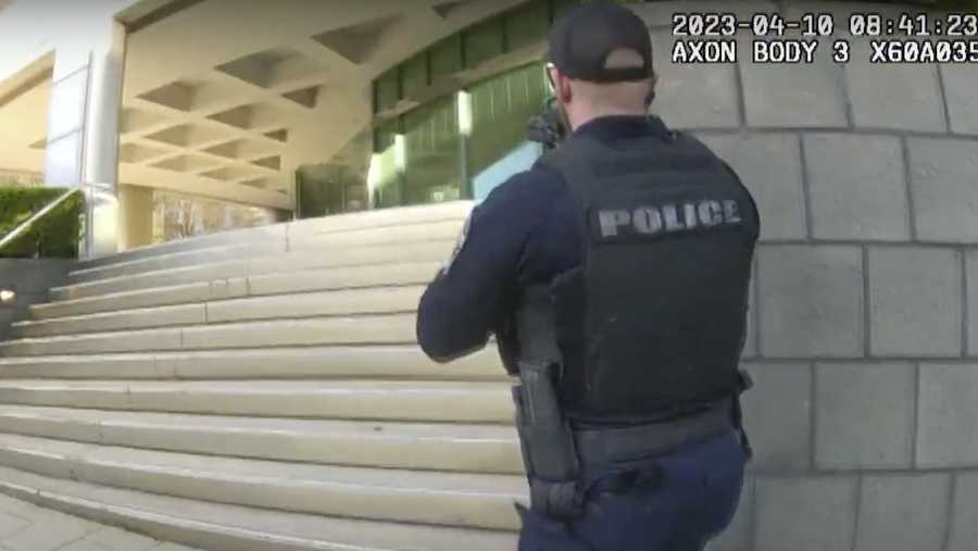 In this screen grab taken from the body cam video of Louisville Metro Police Department Officer Nickolas Wilt, fellow Officer Cory Galloway approaches an active shooting situation, with Wilt following behind him, at Old National Bank, in Louisville, Ky., Monday, April 10, 2023. (Louisville Metro Police Department via AP)