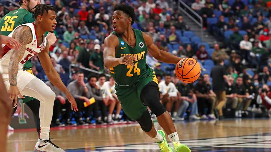 Ben Shungu of the Vermont Catamounts dribbles against Au'Diese Toney of the Arkansas Razorbacks during the first round of the 2022 NCAA Men's Basketball Tournament.