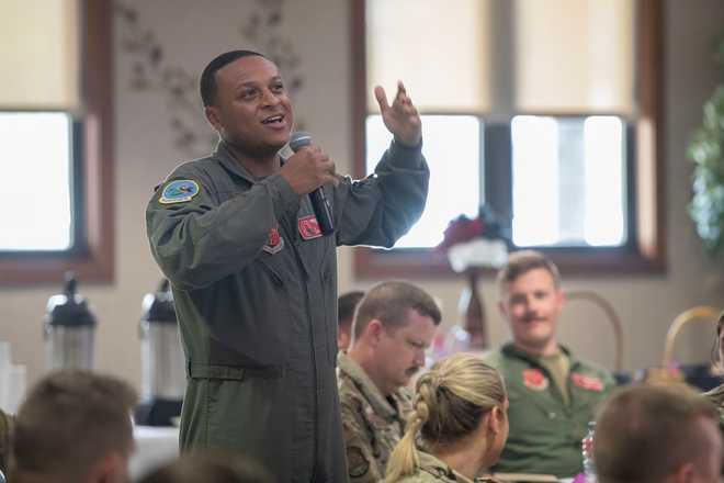 In this photo provided by the U.S. Air National Guard, U.S. Air Force Tech. Sgt. Tyler Simmons, a boom operator assigned to the Ohio National Guard's 121st Air Refueling Wing in Columbus, Ohio, speaks during the Enlisted Leadership Symposium at Youngstown Air Reserve Station in Youngstown, Ohio, on June 27, 2023.