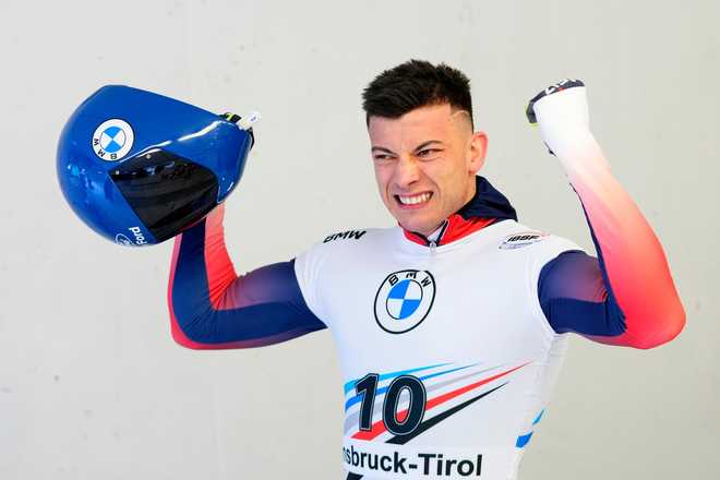 FILE - Matt Weston of Great Britain celebrates after winning the men's skeleton at the Skeleton World Cup race in Igls, near Innsbruck, Austria, Friday, Dec. 15, 2023.