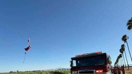 Skydiver rescued after being entangled in Tracy power lines, causing outage