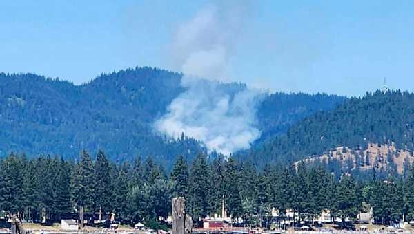 Smoke rises from a fire near Lake Coeur d'Alene, Idaho, where responding firefighters were shot on Sunday, June 29, 2025.