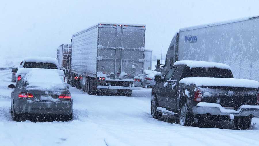This photo provided by Johnny Lim shows a snow covered northbound I-15 in the Cajon Pass between the San Bernardino Mountains and the San Gabriel Mountains in Southern California on Thursday, Dec. 26, 2019. Lim, of Corona, said he's been stuck in his vehicle for about five hours on his way to Las Vegas. A powerful winter storm brought a deluge of rain and snow to Southern California, triggering tornado warnings and bringing post-Christmas travel to a halt on major routes. (Johnny Lim via AP)
