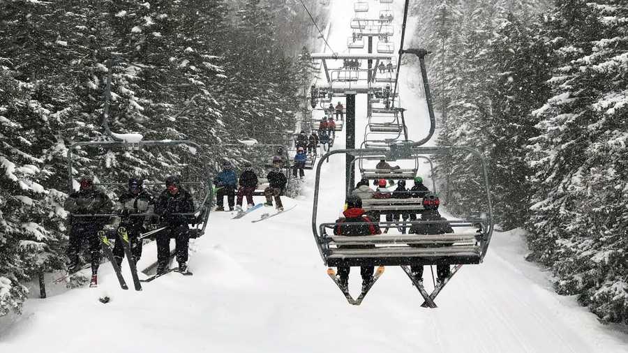 a photo of a ski lift with snow falling at new hampshire's loon mountain