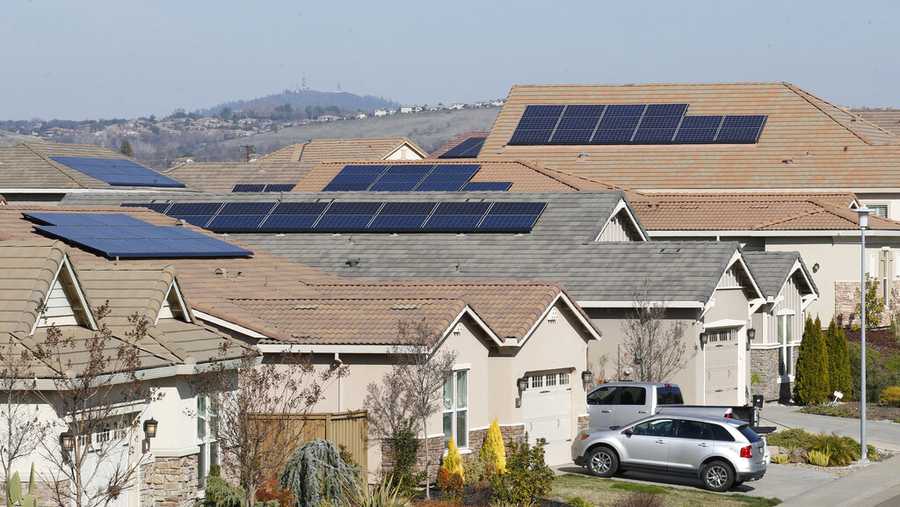 FILE - This photo taken Wednesday, Feb. 12, 2020, shows solar panels on rooftops of a housing development in Folsom, Calif. State regulators at the California Public Utilities Commission are expected to propose reforms that would lower the financial incentives for homeowners who install solar panels. (AP Photo/Rich Pedroncelli, File)