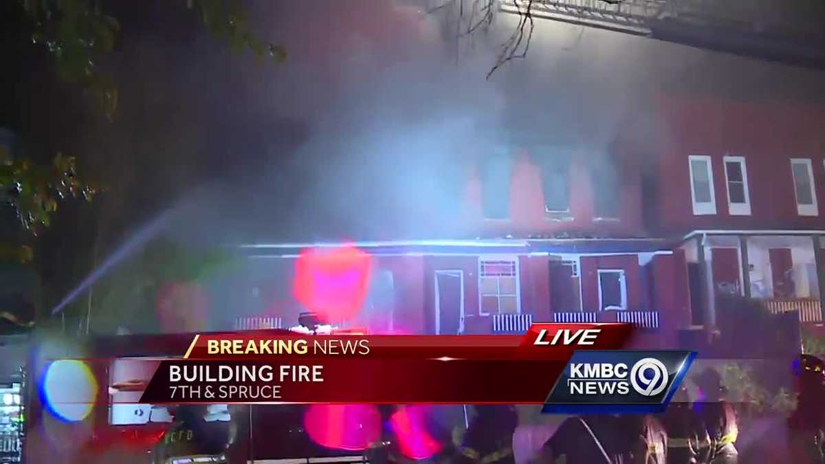 Firefighters work to contain building fire mid-storm