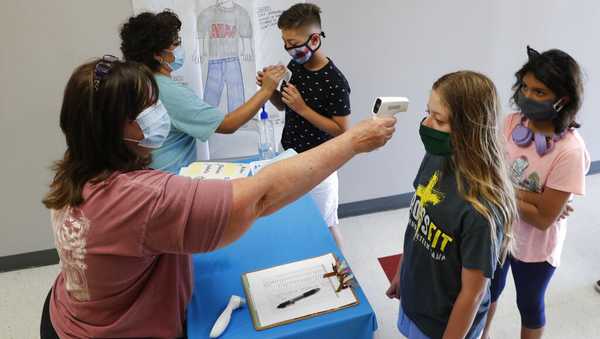 Amid concerns of the spread of COVID-19, science teachers Ann Darby, left, and Rosa Herrera check-in students before a summer STEM camp at Wylie High School Tuesday, July 14, 2020, in Wylie, Texas.