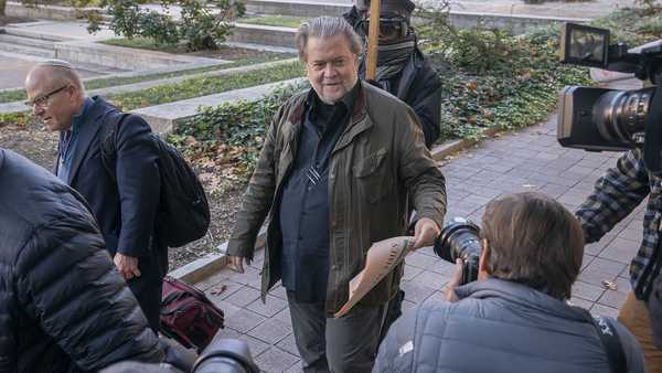 Steve Bannon, center, a longtime ally of former President Donald Trump, convicted of contempt of Congress, arrives at federal court for a sentencing hearing, Friday, Oct. 21, 2022, in Washington.