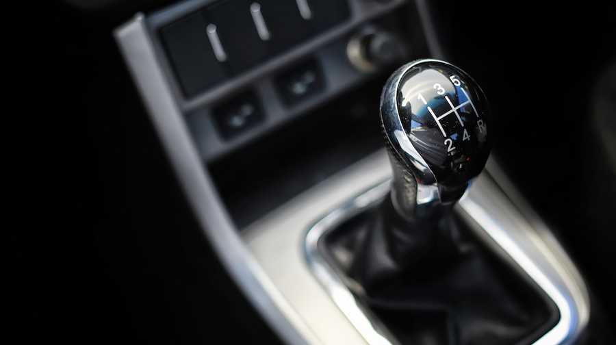 Gear lever. Manual Transmission. Hand on the gear shift in a car.