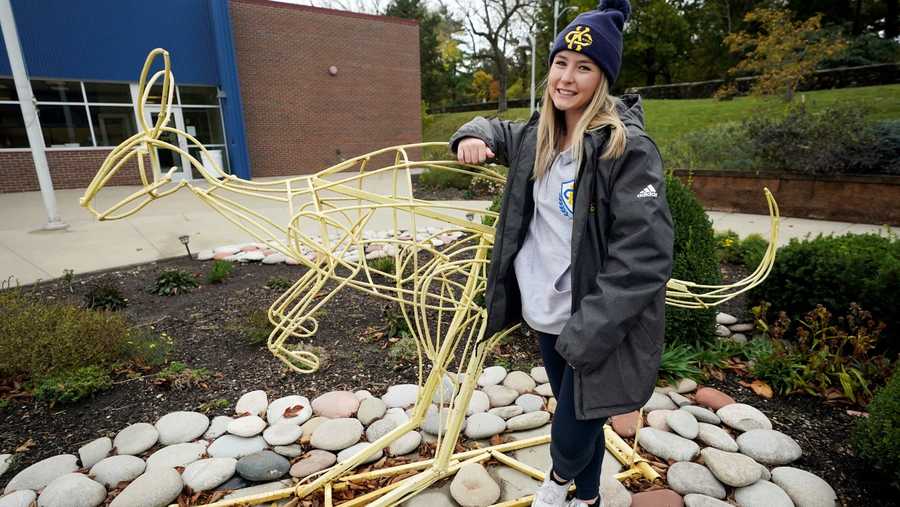 Madison Zurmuehlen stands next to a sculpture of the University of Missouri-Kansas City's mascot outside the soccer facility in Kansas City, Mo., Friday, Oct. 23, 2020.