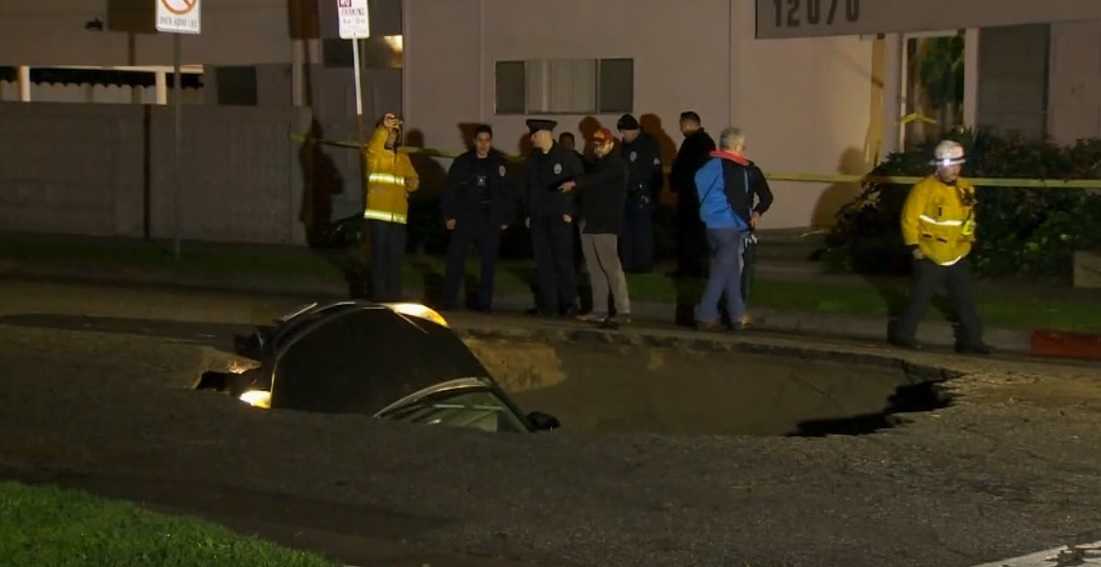 WATCH: Woman Rescued After Car Falls Into 20-foot Sinkhole