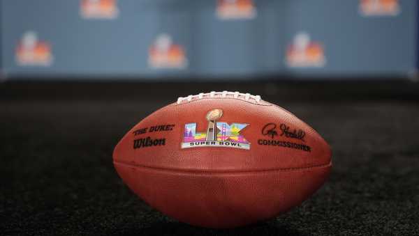 A ceremonial football with the Super Bowl 60 logo sits on the stage after a news conference.