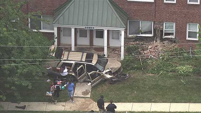 1 hospitalized after SUV crashes into apartment building