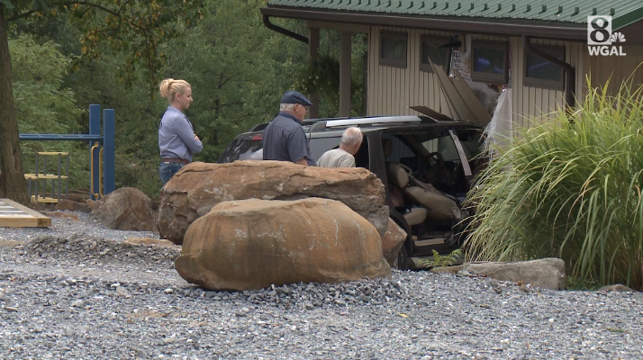 Three people taken to hospital after SUV crashes into building at ...