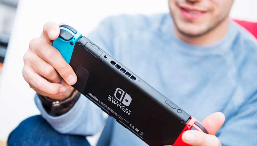 stock photo of person playing Nintendo Switch