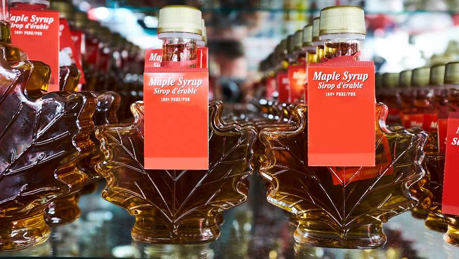 FILE -- Rows of maple leaf shaped bottles containing maple syrup on shop shelf, Canada