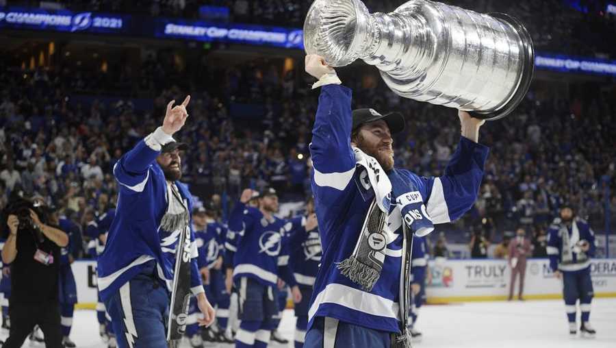 FILE - In this July 7, 2021, file photo, Tampa Bay Lightning center Brayden Point hoists the Stanley Cup after the team defeated the Montreal Canadiens in Game 5 of the NHL hockey Stanley Cup finals in Tampa, Fla. (AP Photo/Phelan Ebenhack, File)