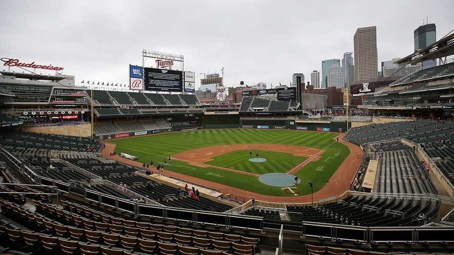 The scoreboard at Target Field explains the postponement of the baseball game between the Minnesota Twins and Boston Red Sox, Monday, April 12, 2021, in Minneapolis. The Twins postponed their game against the Red Sox because of safety concerns following the fatal police shooting of a Black man and the potential for unrest in the area.