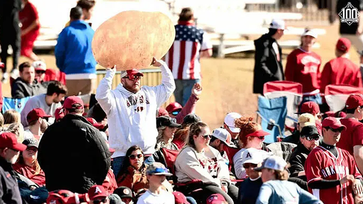 Why is there a man waving a giant potato at Hogs baseball games?
