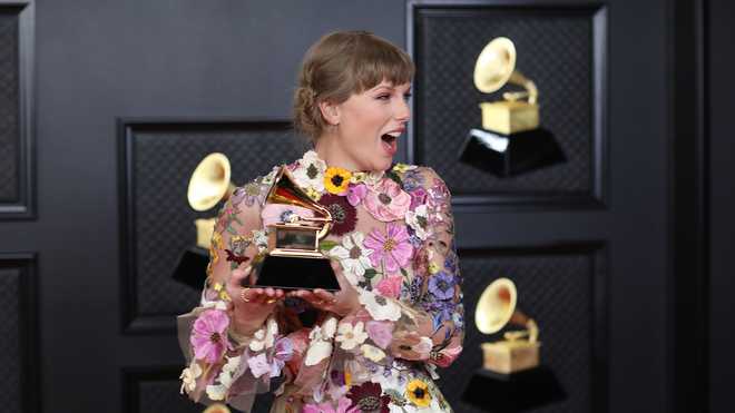 Taylor Swift with her Grammy for winning Album of the Year on the red carpet at the 63rd Annual Grammy Awards, at the Los Angeles Convention Center, in downtown Los Angeles, CA, Sunday, Mar. 14, 2021.