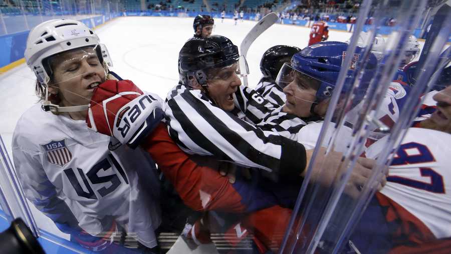 Referees break up fight between the United States and the Czech Republic players during the first period of the quarterfinal round of the men's hockey game at the 2018 Winter Olympics in Gangneung, South Korea, Wednesday, Feb. 21, 2018