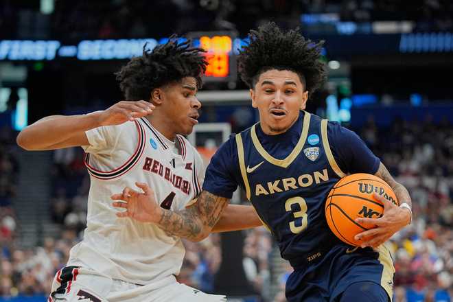 Akron guard Sharron Young (3) makes a move to get past Texas Tech guard Christian Anderson, left, during the first half in the first round of the NCAA college basketball tournament, Friday, March 20, 2026.
