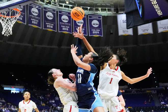 Villanova guard Jasmine Bascoe (11) shoots between Texas Tech guard Bailey Maupin and forward Jalynn Bristow (1) during the first half in the first round of the NCAA college basketball tournament, Friday, March 20, 2026, in Baton Rouge, La.