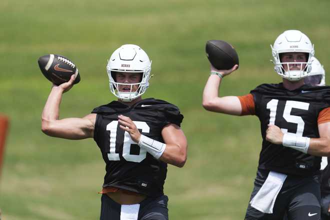 Texas quarterback Arch Manning (16) and quarterback Trey Owens (15) go through drills during an NCAA college football practice in Austin, Texas, Wednesday, July 30, 2025.