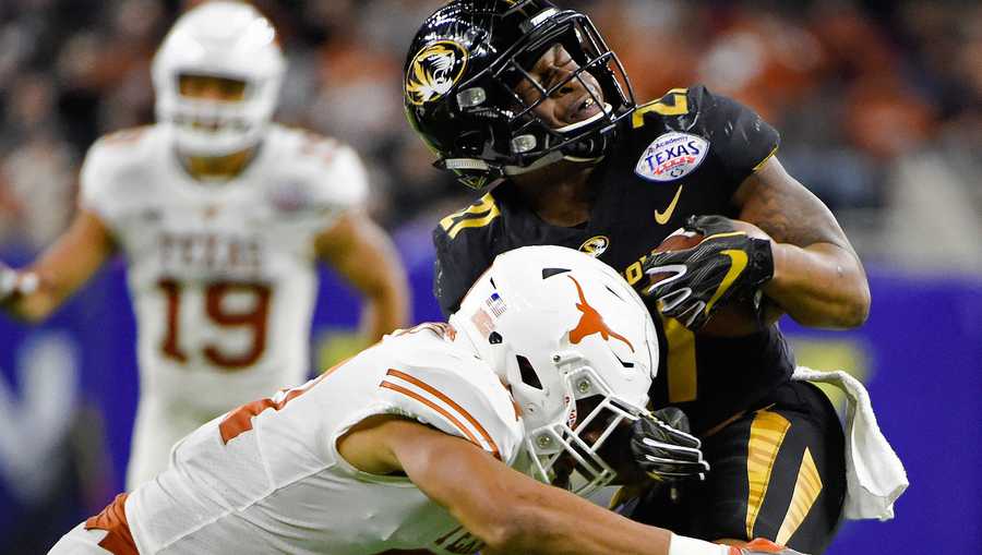 Missouri running back Ish Witter, right, is hit by Texas defensive back Jason Hall during the first half of the Texas Bowl NCAA college football game Wednesday, Dec. 27, 2017, in Houston. (AP Photo/Eric Christian Smith)