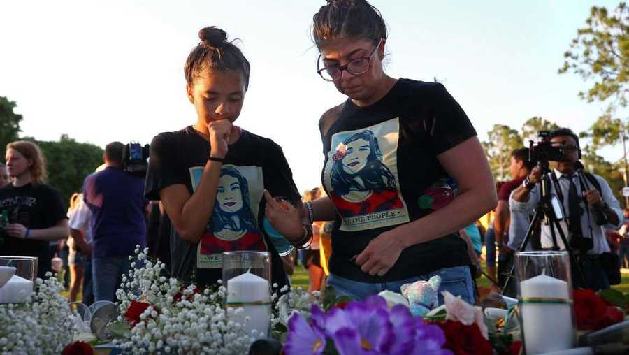 People dropped flowers in honor for the victims of the Santa Fe High School mass shooting during a vigil at Texas First Bank Friday, May 18, 2018, in Santa Fe, Texas.