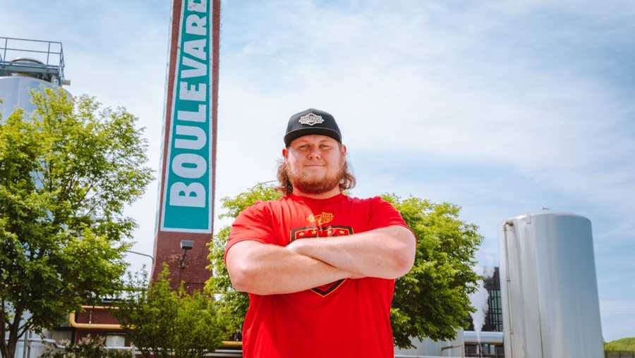 chiefs center creed humphrey standing in front of boulevard brewing co.