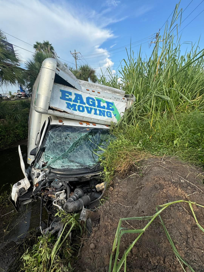 Moving truck crashes into cars and lands in south Fort Myers drainage canal.