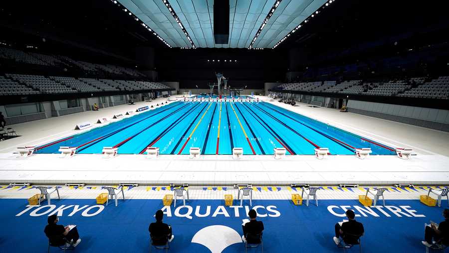 FILE - In this April 26, 2021, file photo, Tokyo 2020 Olympic Games Organizing staff prepare a Paralympic swimming test event at the Tokyo Aquatics Center, one of the venues of the Tokyo 2020 Olympic and Paralympic Games, in Tokyo.