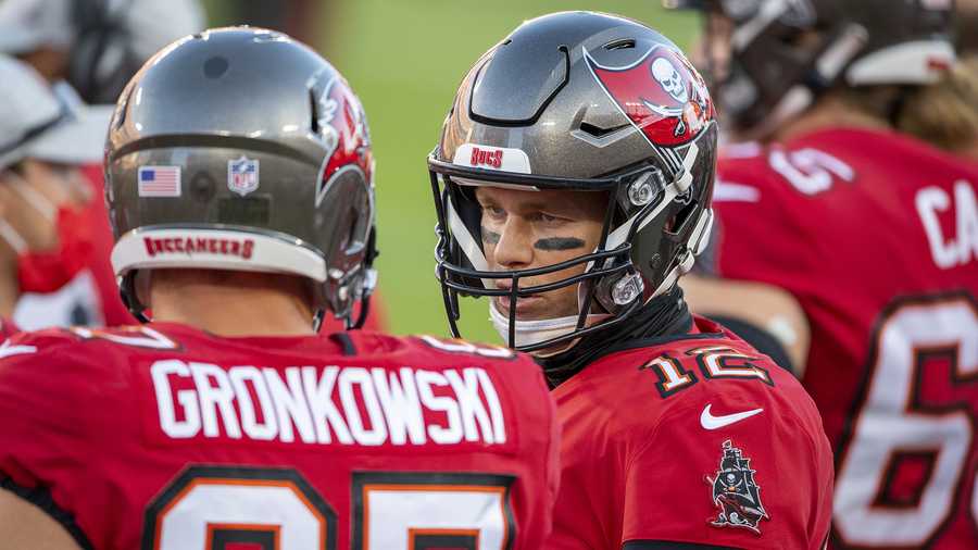 Tampa Bay Buccaneers quarterback Tom Brady (12) talks with Tampa Bay Buccaneers tight end Rob Gronkowski (87) on sidelines as the Buccaneers take on the Kansas City Chiefs during an NFL football game, Sunday, Nov. 29, 2020, in Tampa, Fla. (AP Photo/Doug Murray)