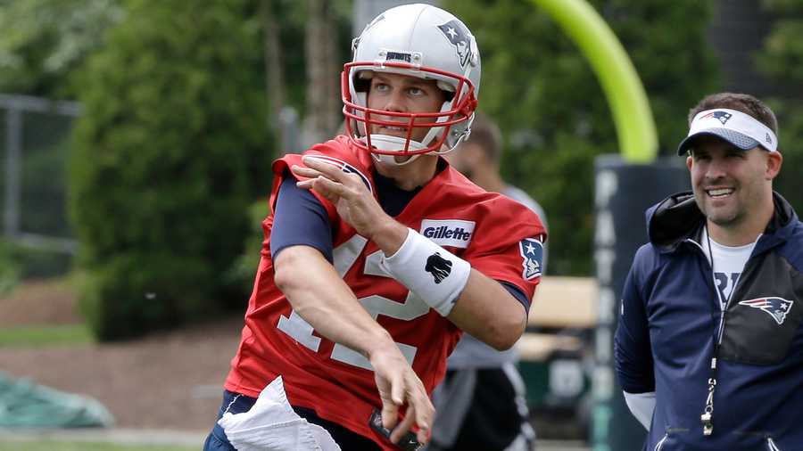 In this file photo, quarterback Tom Brady (12) follows through on a pass as New England Patriots offensive coordinator Josh McDaniels, right, looks on during an NFL football minicamp practice, Thursday, June 7, 2018, in Foxborough, Mass. (AP Photo)