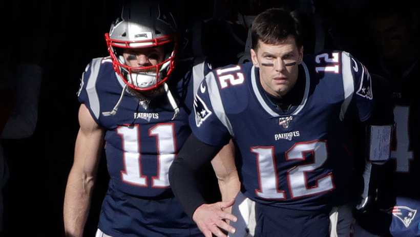 New England Patriots wide receiver Julian Edelman, left, and quarterback Tom Brady run onto the field for an NFL football game against the Miami Dolphins, Sunday, Dec. 29, 2019, in Foxborough, Mass.