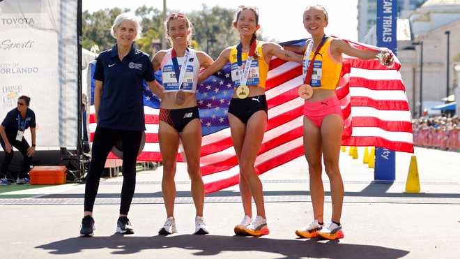 Emily Sisson, Fiona O' Keefe, and Dakota Lindwurm celebrate their second-place finishes and their 