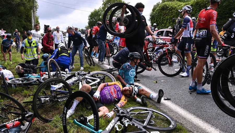 Team B&B KTM's Bryan Coquard of France (R) and a Team Alpecin Fenix' rider lie on the ground after crashing during the 1st stage of the 108th edition of the Tour de France cycling race, 197 km between Brest and Landerneau, on June 26, 2021.
